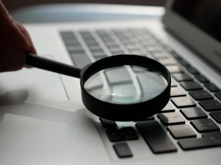 magnifying glass on laptop keyboard